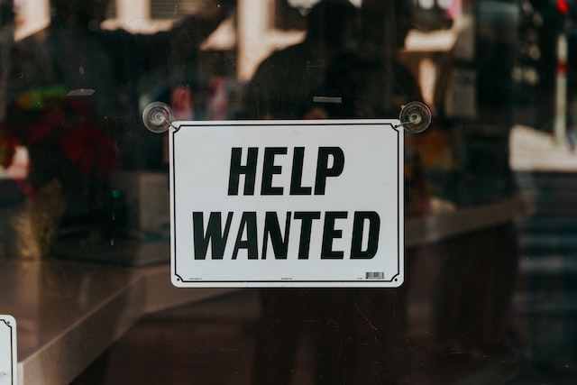 help wanted sign hanging in windo