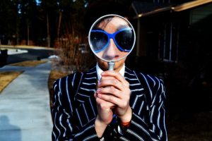 Magnifying glass in front of a person's face