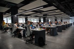 large room of workers on computers