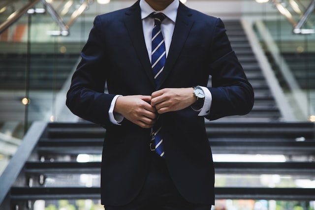 Person wearing a suit on stairs